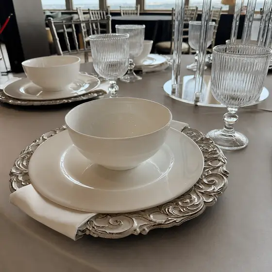 Ivory place setting with charger and crystal goblet at Slate
