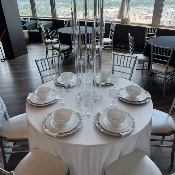 Ivory tablecloth set with candelabra over the Oklahoma City skyline
