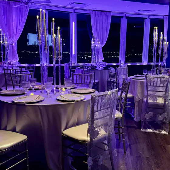 Reception lit by thirty candelabras at night